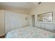 Comfortable bedroom with light walls, a ceiling fan and large closet with wood floors at 240 Riviera Ct, Punta Gorda, FL 33950