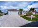 An inviting home featuring a well-maintained lawn and a spacious driveway at 240 Riviera Ct, Punta Gorda, FL 33950