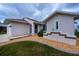 Charming home with manicured lawn, and decorative exterior details at 240 Riviera Ct, Punta Gorda, FL 33950