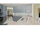 Spacious kitchen showcasing gray cabinets, granite countertops, stainless steel sink, and an open dining area at 240 Riviera Ct, Punta Gorda, FL 33950
