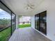 Inviting screened porch featuring tiled floors, neutral paint, and fan at 240 Riviera Ct, Punta Gorda, FL 33950
