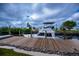 Large boat parked along the wooden backyard dock at 240 Riviera Ct, Punta Gorda, FL 33950