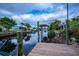 Backyard canal features a dock and a boat lift at 240 Riviera Ct, Punta Gorda, FL 33950