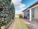 Side yard featuring a screened lanai and a well-maintained lawn at 2419 Daisy Dr, North Port, FL 34289