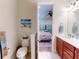 Bathroom with a toilet and vanity, leading to the bedroom at 2419 Daisy Dr, North Port, FL 34289