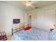 Cozy bedroom with a ceiling fan and view into another room at 2419 Daisy Dr, North Port, FL 34289