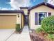 Home exterior featuring warm stucco, tiled roof, and well-maintained landscaping at 2419 Daisy Dr, North Port, FL 34289