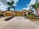 Charming home with manicured landscaping, two-car garage, and a tile roof at 2419 Daisy Dr, North Port, FL 34289