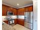 Modern kitchen featuring stainless steel appliances, granite countertops, and ample cabinet space at 2419 Daisy Dr, North Port, FL 34289