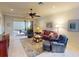 Comfortable living room featuring a ceiling fan, neutral paint, and sliding doors to an outdoor space at 2419 Daisy Dr, North Port, FL 34289