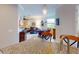 Open concept living room featuring hardwood floors, neutral paint, dining area, and kitchen at 2419 Daisy Dr, North Port, FL 34289