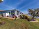 Landscaped backyard features a brick paver patio with a view of the water and an inviting, shaded screen porch at 24313 Westgate Blvd, Punta Gorda, FL 33980