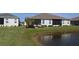 Beautiful backyard view overlooking a peaceful pond and lush green space, with screened in patio at 24313 Westgate Blvd, Punta Gorda, FL 33980