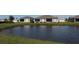 Scenic backyard view overlooking a tranquil pond and well-maintained lawn at 24313 Westgate Blvd, Punta Gorda, FL 33980