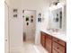 Bright bathroom featuring a large mirror and access to the adjacent toilet room at 24313 Westgate Blvd, Punta Gorda, FL 33980