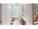 Charming bathroom featuring tiled floors, tub with shower and cherry wood vanity with solid white counter top at 24313 Westgate Blvd, Punta Gorda, FL 33980