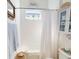 Cozy bathroom with white cabinets, tiled tub, and cute marine-themed decorations for a beachy, relaxed vibe at 24313 Westgate Blvd, Punta Gorda, FL 33980
