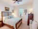 Comfortable bedroom featuring neutral colors and ample natural light from the window with wood-look window blinds at 24313 Westgate Blvd, Punta Gorda, FL 33980