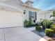 Charming home exterior featuring a two-car garage, well-manicured landscaping, and a neatly paved driveway at 24313 Westgate Blvd, Punta Gorda, FL 33980