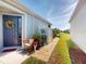 Charming home featuring a welcoming front door with a decorative floral wreath, inviting curb appeal at 24313 Westgate Blvd, Punta Gorda, FL 33980