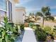 Inviting walkway with lush, manicured landscaping, leading to a charming residence at 24313 Westgate Blvd, Punta Gorda, FL 33980