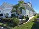Charming single-story home with a well-manicured front yard featuring lush landscaping and a welcoming walkway at 24313 Westgate Blvd, Punta Gorda, FL 33980