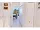 Hallway leading to a bedroom with tile floors and white doors and closet providing a bright and airy feeling at 24313 Westgate Blvd, Punta Gorda, FL 33980
