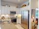 Well-lit kitchen featuring stainless steel appliances, white cabinetry, and ample counter space for cooking at 24313 Westgate Blvd, Punta Gorda, FL 33980