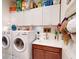 Bright laundry room with sink and upper storage cabinets for convenience and organization at 24313 Westgate Blvd, Punta Gorda, FL 33980
