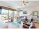 Cozy living room featuring hardwood floors, comfortable seating, and a scenic view of the pond and patio at 24313 Westgate Blvd, Punta Gorda, FL 33980