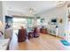 Bright living room with wood floors, ceiling fan, leather chairs and sliding glass doors to outdoor space at 24313 Westgate Blvd, Punta Gorda, FL 33980