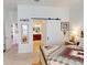 Comfortable main bedroom with a barn door leading to the ensuite bathroom and ample closet space at 24313 Westgate Blvd, Punta Gorda, FL 33980