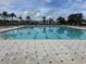 Large community pool with ample seating and palm trees for a resort-like experience at 24313 Westgate Blvd, Punta Gorda, FL 33980
