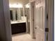 Well-lit bathroom featuring a sleek vanity with dark cabinets and a glass-enclosed shower at 244 Surinam St, Punta Gorda, FL 33983