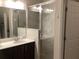 Bright bathroom with a large mirror, modern vanity, and a walk-in shower with stylish gray tiles at 244 Surinam St, Punta Gorda, FL 33983