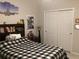 Comfortable bedroom with a bed, a nightstand, and a closet, decorated with wall art at 244 Surinam St, Punta Gorda, FL 33983