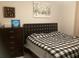 Bedroom featuring a bed with a black and white patterned comforter and a dark wood dresser at 244 Surinam St, Punta Gorda, FL 33983