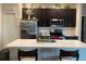 Modern kitchen with stainless steel appliances, white countertops, and dark wood cabinetry at 244 Surinam St, Punta Gorda, FL 33983