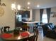 Open-concept kitchen with stainless steel appliances, an island with seating, and stylish lighting fixtures at 244 Surinam St, Punta Gorda, FL 33983