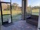 Screened patio featuring brick flooring and outdoor seating, overlooking a green yard at 244 Surinam St, Punta Gorda, FL 33983