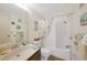 Bathroom with integrated tub and shower combination with stylish nautical-themed decor and fixtures at 25225 Rampart Blvd # 1604, Punta Gorda, FL 33983