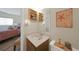 Well-lit bathroom with sink, white countertops, nautical decor, and view into bedroom at 25225 Rampart Blvd # 1604, Punta Gorda, FL 33983
