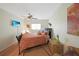 Bright bedroom featuring a decorative headboard, ceiling fan, and a window offering natural light at 25225 Rampart Blvd # 1604, Punta Gorda, FL 33983