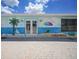 Exterior of building with murals depicting a beachfront scene with palm trees and beach umbrellas at 25225 Rampart Blvd # 1604, Punta Gorda, FL 33983