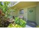 Charming condo front door with garden, seating area, and decorative wreath for a welcoming entrance at 25225 Rampart Blvd # 1604, Punta Gorda, FL 33983