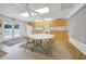 The bright community kitchen features wooden cabinets, white appliances, and a round dining table at 25225 Rampart Blvd # 1604, Punta Gorda, FL 33983