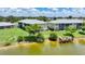 Aerial view of the condos overlooking the lake with a wooden pier at 25225 Rampart Blvd # 1604, Punta Gorda, FL 33983