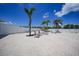 The community pool deck features lounge chairs, tables, palm trees, and a gazebo at 25225 Rampart Blvd # 1604, Punta Gorda, FL 33983