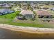 Stunning lakefront property featuring a screened-in pool, landscaped yard, and a private setting at 26373 Madagascar, Punta Gorda, FL 33983