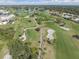 Scenic aerial view of lush golf course, featuring manicured greens, serene ponds, and surrounding residential community at 26373 Madagascar, Punta Gorda, FL 33983